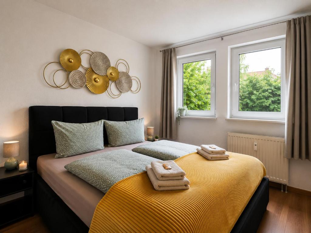 a bedroom with a large bed with towels on it at Apartment Alex in Pirna