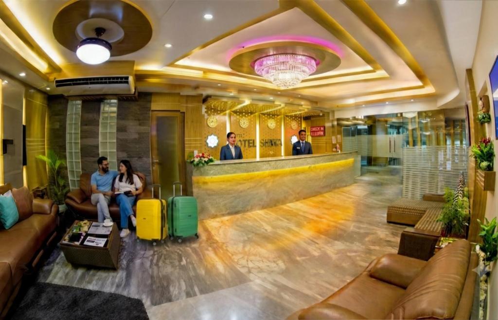 a lobby of a hotel with people sitting at a bar at Hotel Shuktara Dhaka in Dhaka