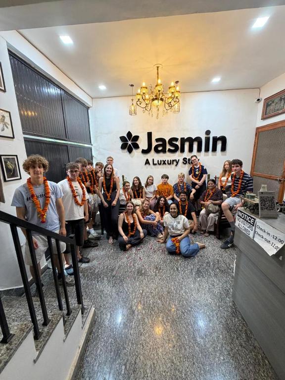 a group of people posing for a picture in a store at Jasmin A Luxury Stay-900m Walk To The Taj Mahal,Free Parking in Agra