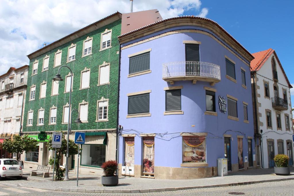a blue and green building on a city street at SeiaVilla - 4 Fontes in Seia