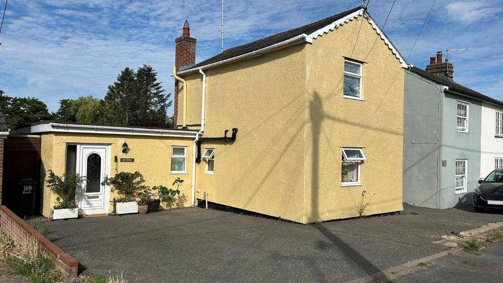 a yellow house is parked in a parking lot at Berkley Cottage in Colchester