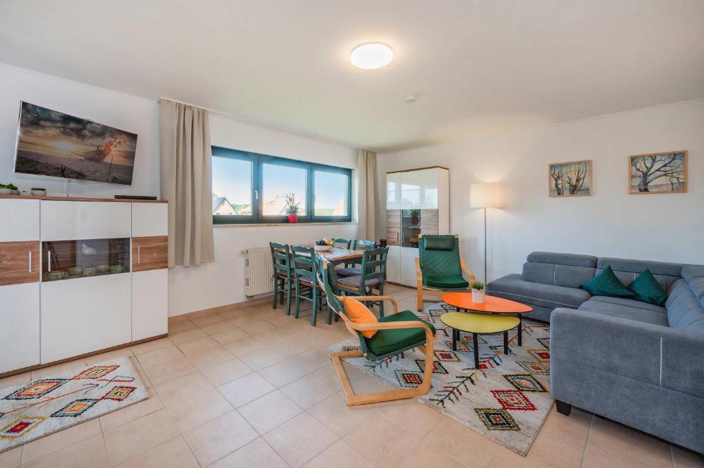 a living room with a couch and a table at Lindenstraße Ferienwohnung Anker in Koserow