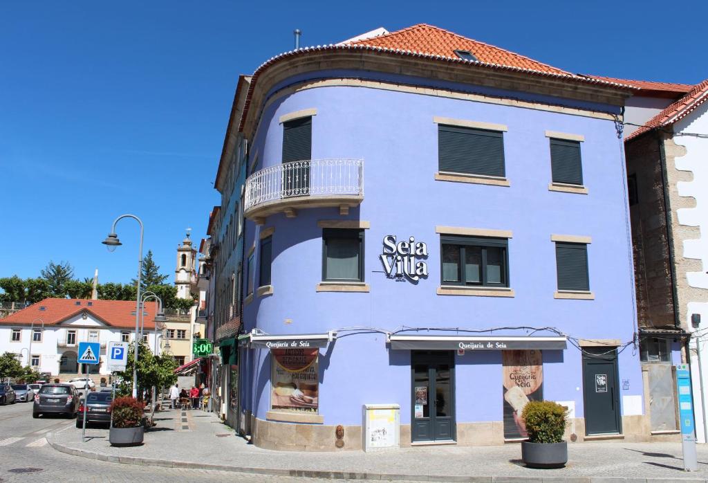 a blue building on the corner of a street at SeiaVilla - São Pedro in Seia