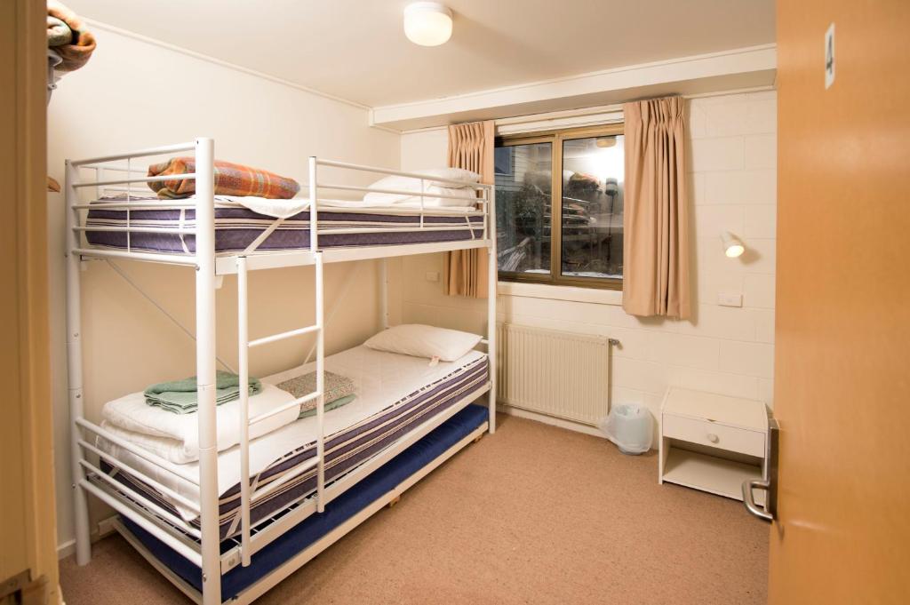 a bunk bed room with two bunk beds and a window at Ski Club of Victoria - Kandahar Lodge in Mount Buller