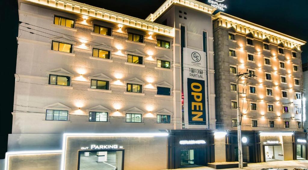 a large building with a sign in front of it at cs프라자호텔 in Cheonan