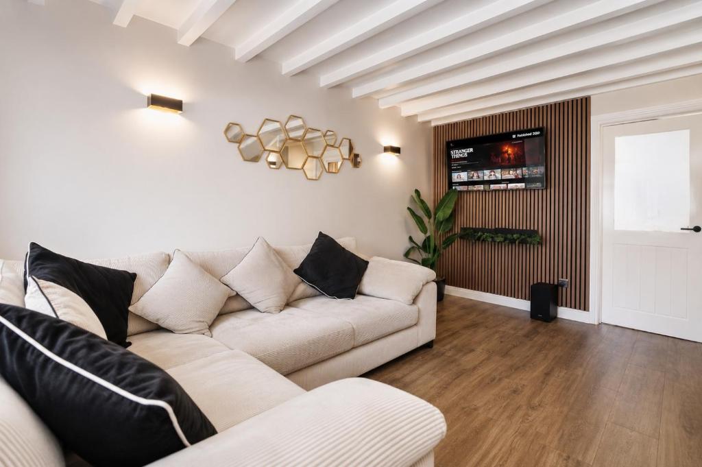 a living room with a white couch and a tv at Beautiful Abode in The Bath Cotswolds in Frome