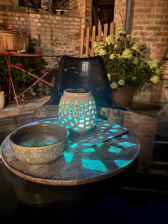 a table with a bowl and a vase on it at Cine in Sainte-Menehould