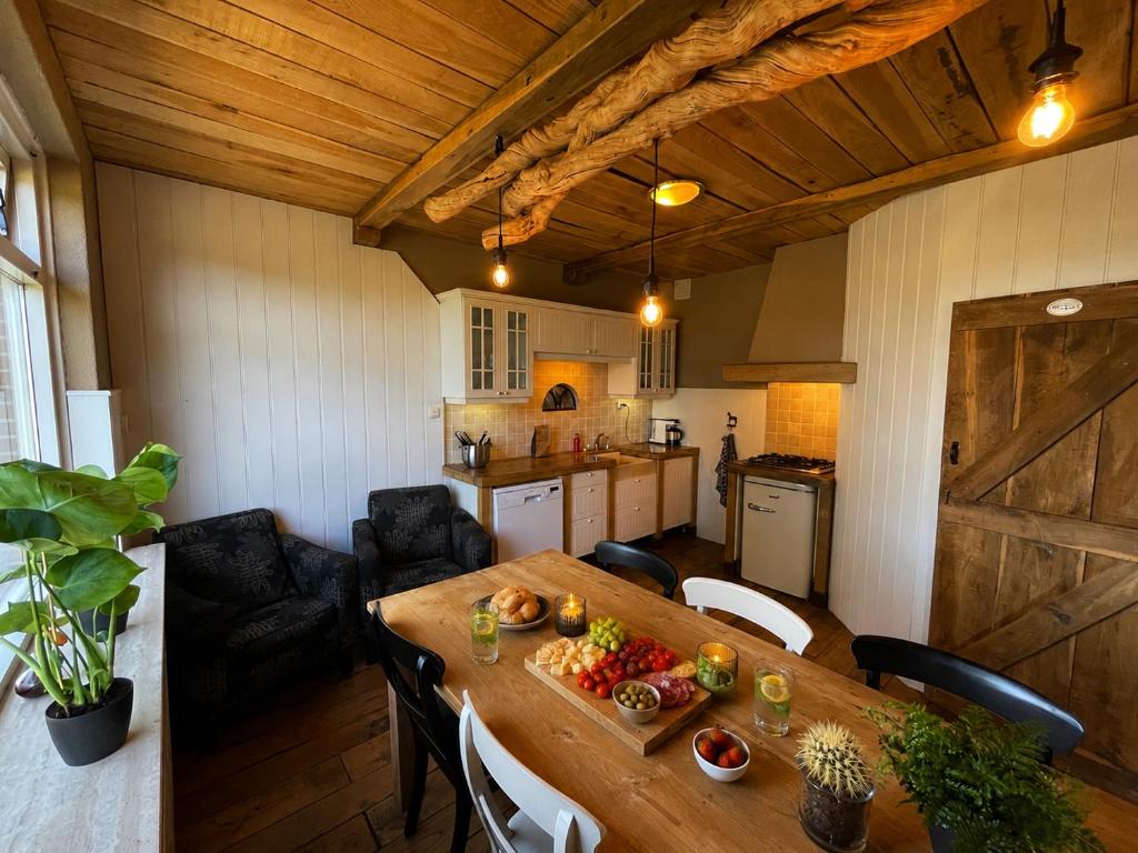 a kitchen with a wooden table with fruit on it at Woonboerderij Markelo in Markelo