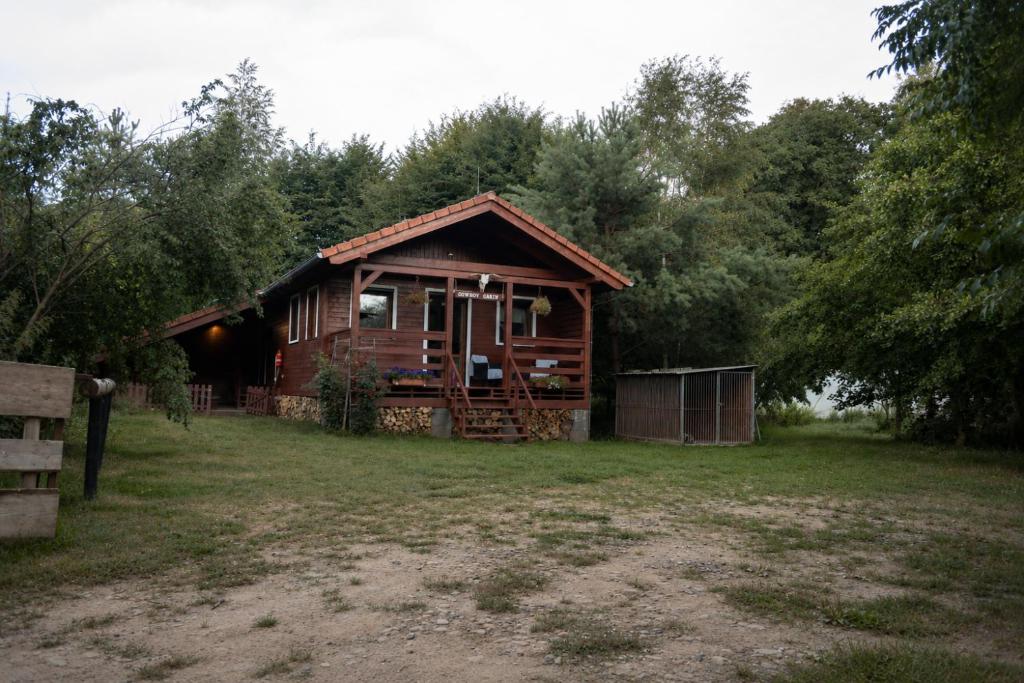 a log cabin in the middle of a field at Domek v údolí in Božanov