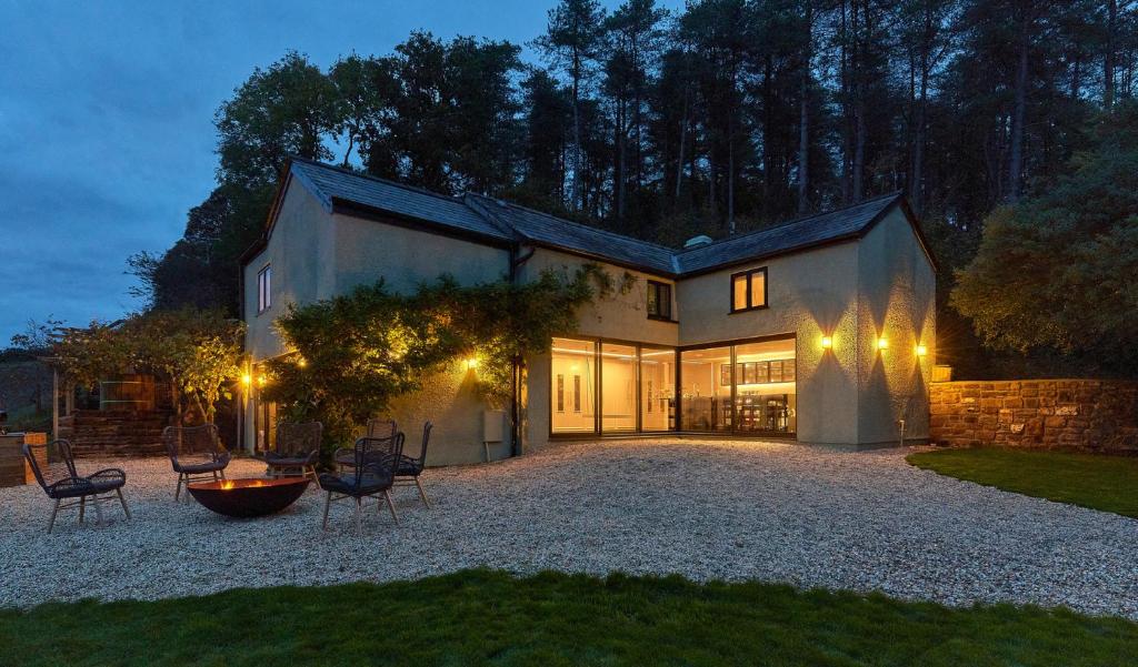 a large house with chairs and lights in the yard at Providence Cottage in Monmouth