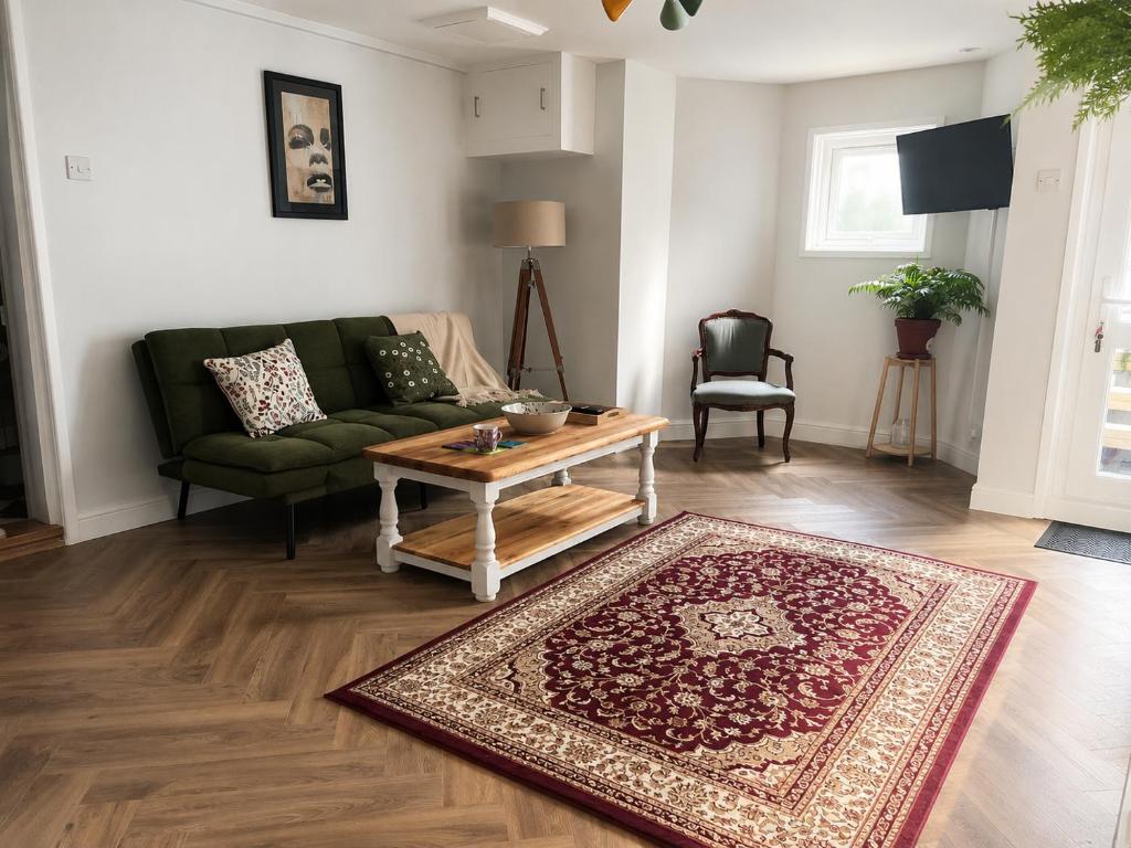 a living room with a green couch and a coffee table at Little B - Artist owned boutique apartment near Southsea beach in Portsmouth