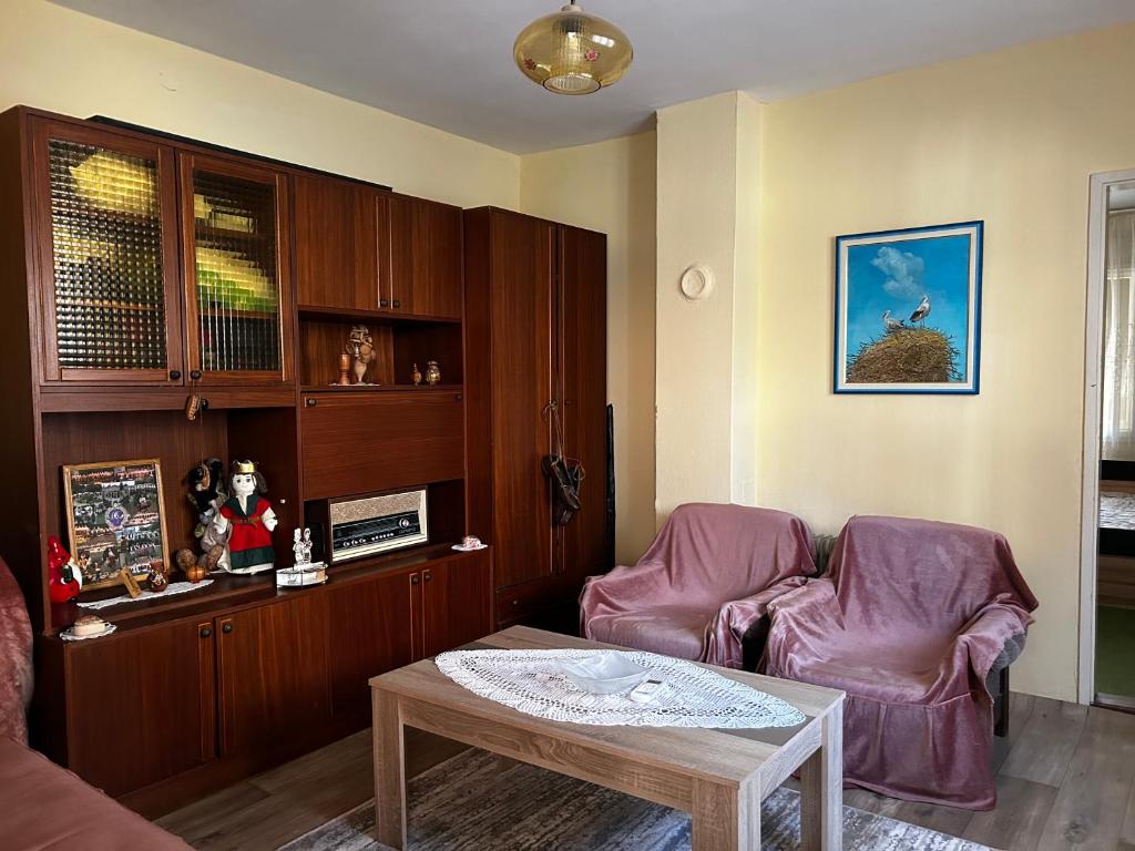 a living room with two chairs and a table at Sremac in Kupinovo