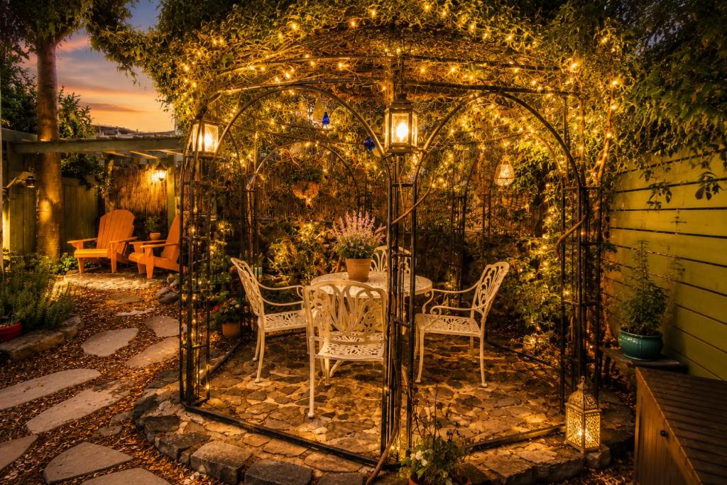 a gazebo with a table and chairs and lights at סתיו בגולן in Qasrîne