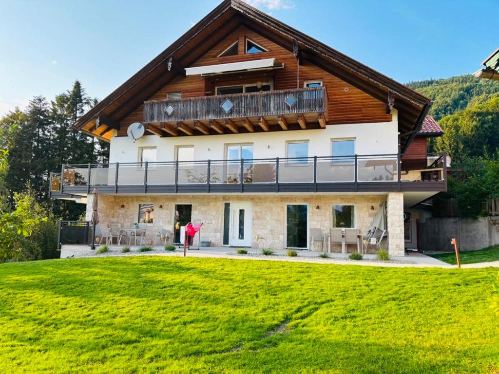 a large house with a wooden roof at Ferienwohnung Mondseeblick in Tiefgraben