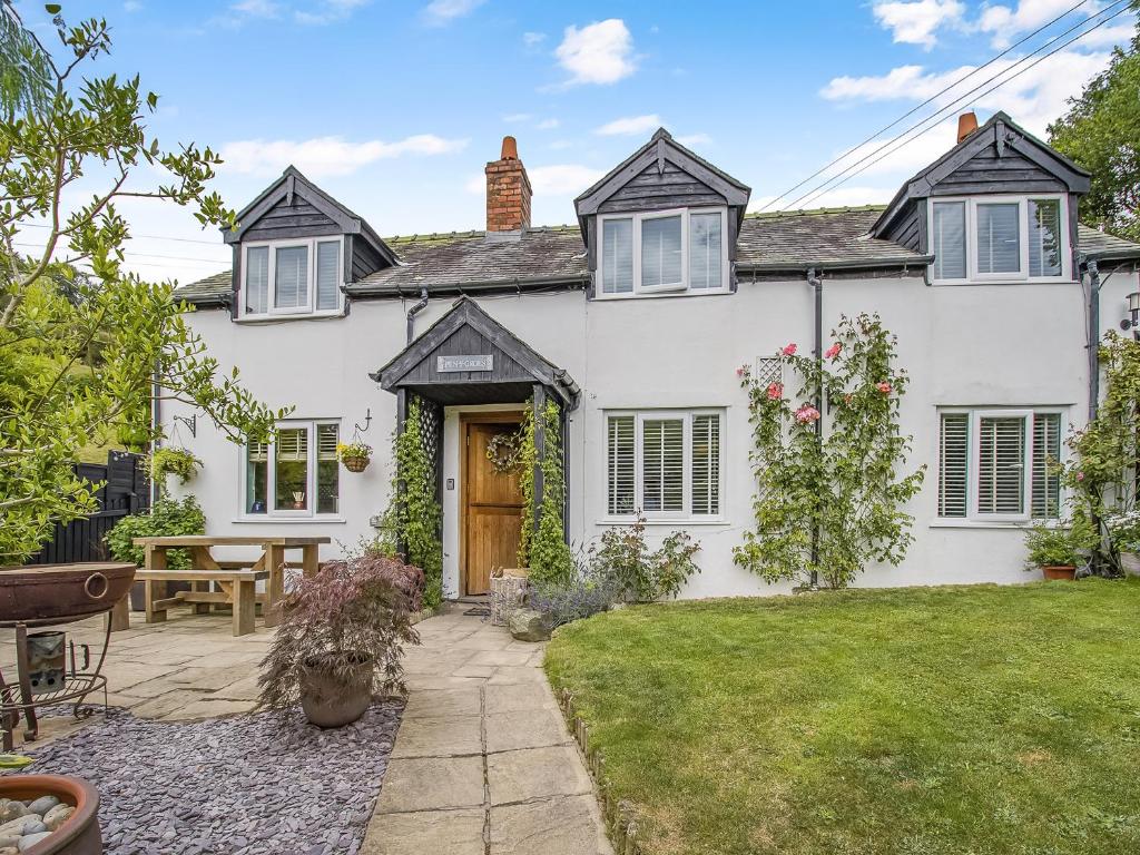 an exterior view of a white house with a yard at Pen Y Groes in Welshpool