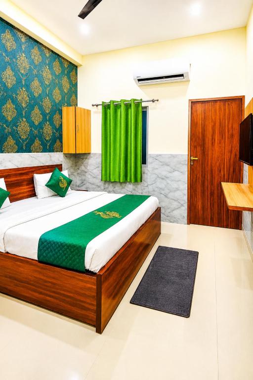 a bedroom with a bed and a green curtain at Hotel Regal Delight Star Taj - Best Rated Area #hygienic and Affordable Rooms, Check in Guarantee,Near Taj mahal in Agra