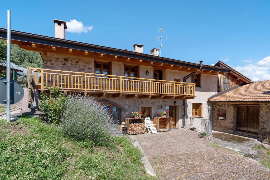 a large house with a balcony on top of it at Agritur Maso Bornie in Grauno