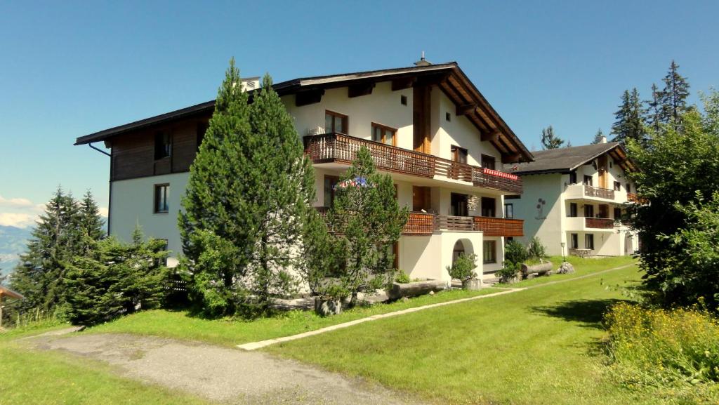 una casa en una colina con un patio verde en Haus Primula Pizol, en Wangs