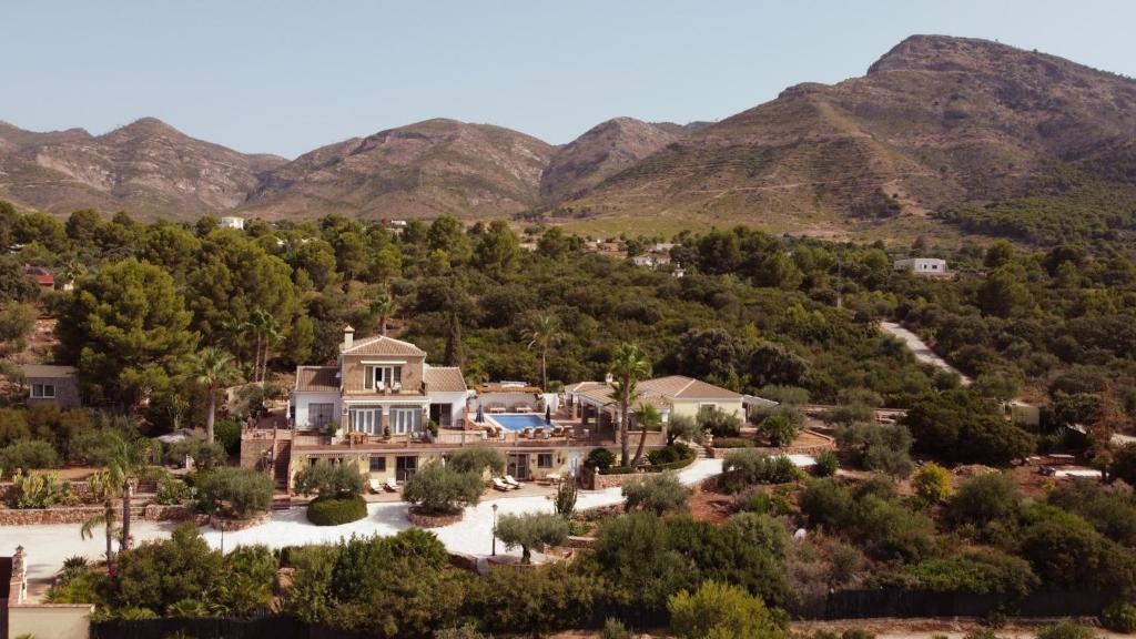 an aerial view of a house with mountains in the background at Finca Sonrisa in Alhaurín el Grande