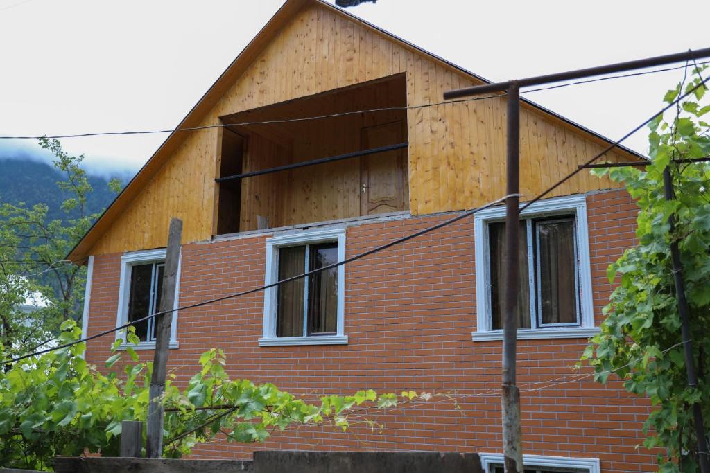 a house with a boarded up window on it at Guest House Mercury in Khulo
