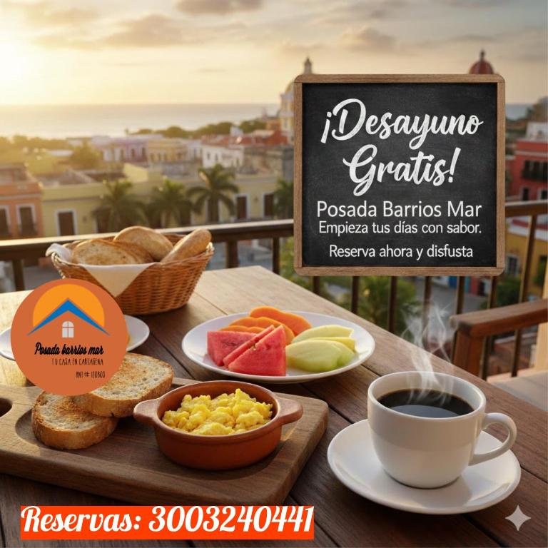 a table with a tray of breakfast foods and a cup of coffee at posada barrios mar in Cartagena de Indias