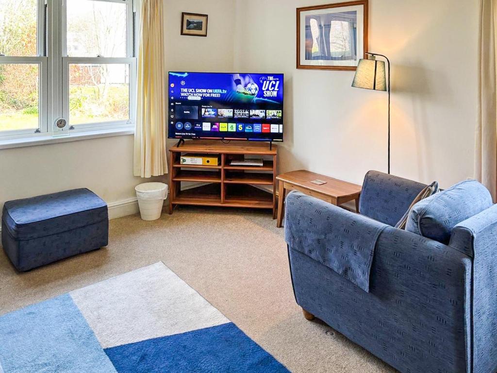 a living room with a couch and a flat screen tv at 11 Elm Court in Keswick
