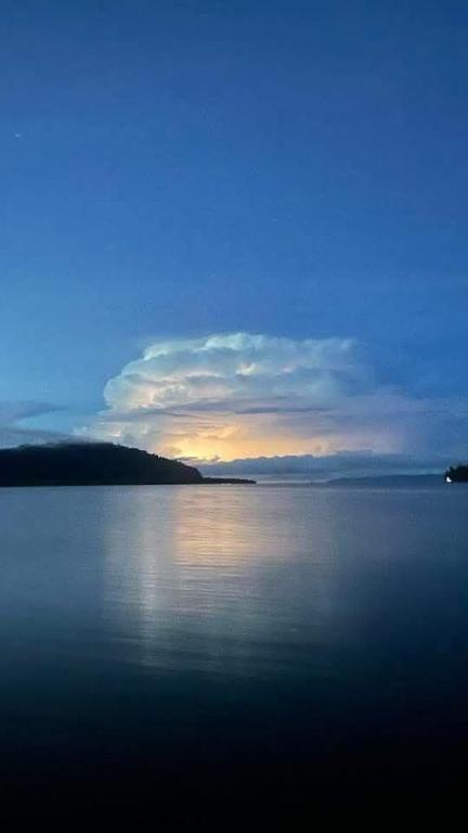 a sunset over a large body of water at Club Fred in Punta Mala