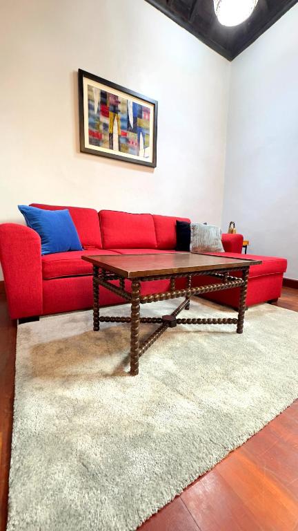 a living room with a red couch and a table at Casa Tradicional Canaria - Gara in Garachico
