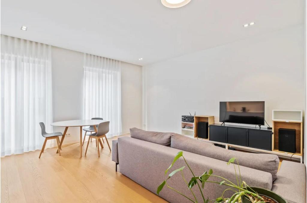 a living room with a couch and a table at Royal Hamilius Luxury 1 bed in Luxembourg