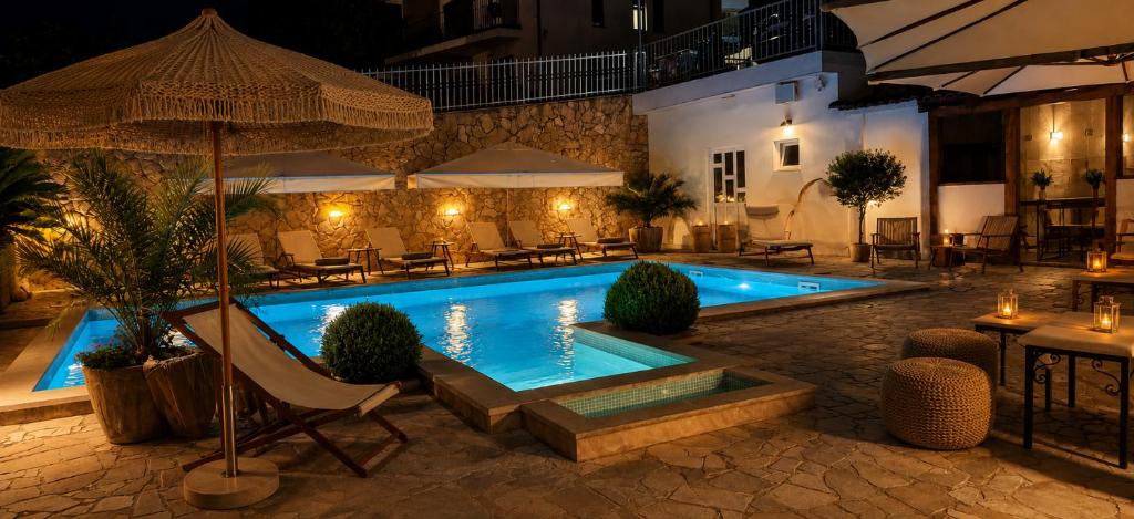 a swimming pool in a resort at night at Hotel B&B Villa Paula in Trogir