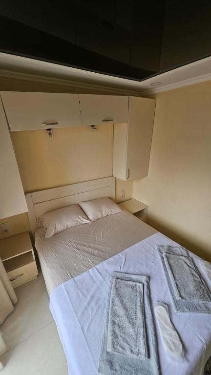 a large bed in a small room with at Malta Hotel in Batumi