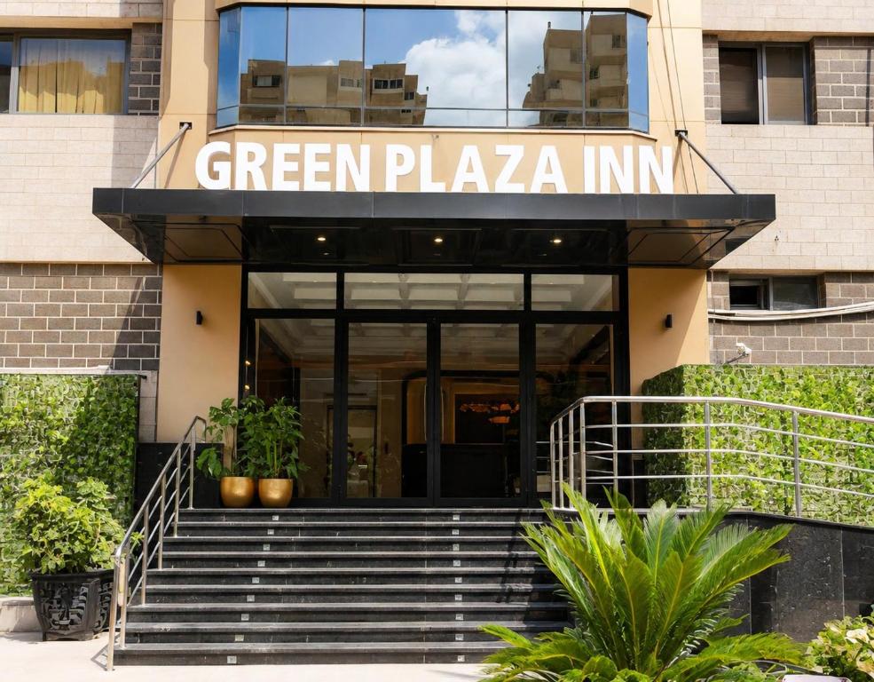 a green plaza inn building with stairs in front at Green Plaza Inn in Alexandria