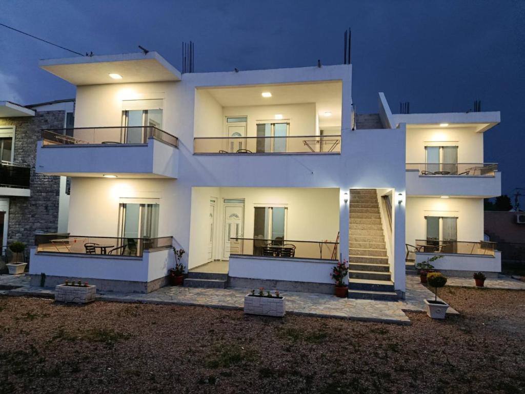 a large white building with a staircase in front of it at Vesa&Veton in Donji Štoj