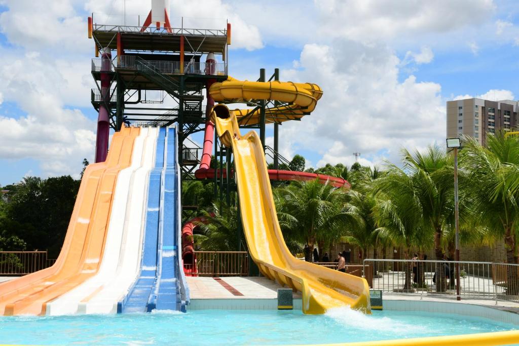 a water park with a slide in a pool at Spazzio diRoma - Apartamentos JN in Caldas Novas