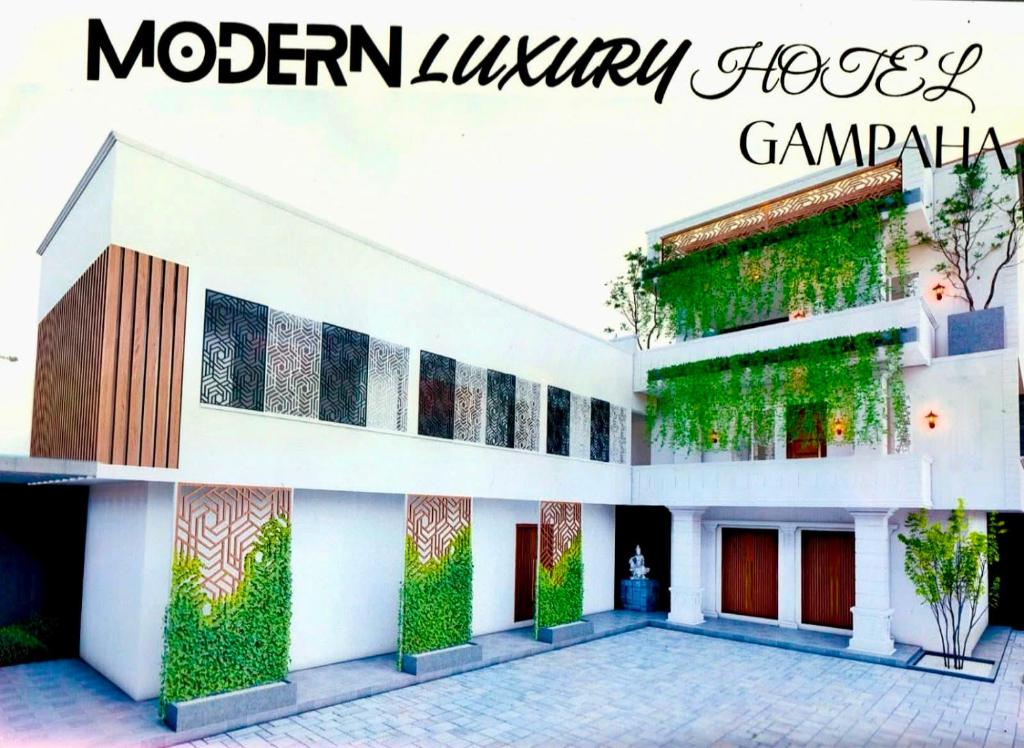 a white building with plants on the side of it at Rest Inn Tourist Hotel in Gampaha