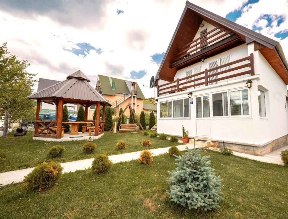 a house with a gazebo in a yard at Guest House SARA in Žabljak