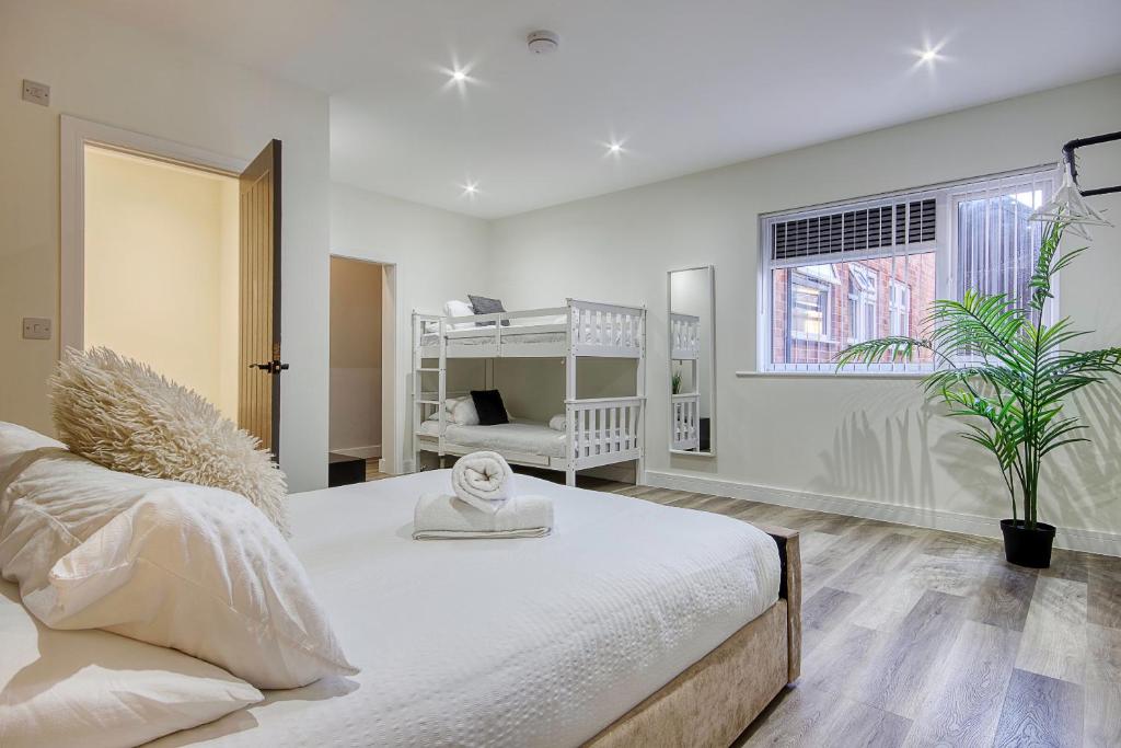 a bedroom with a large white bed and a window at The Studio Castle Lane in Bournemouth
