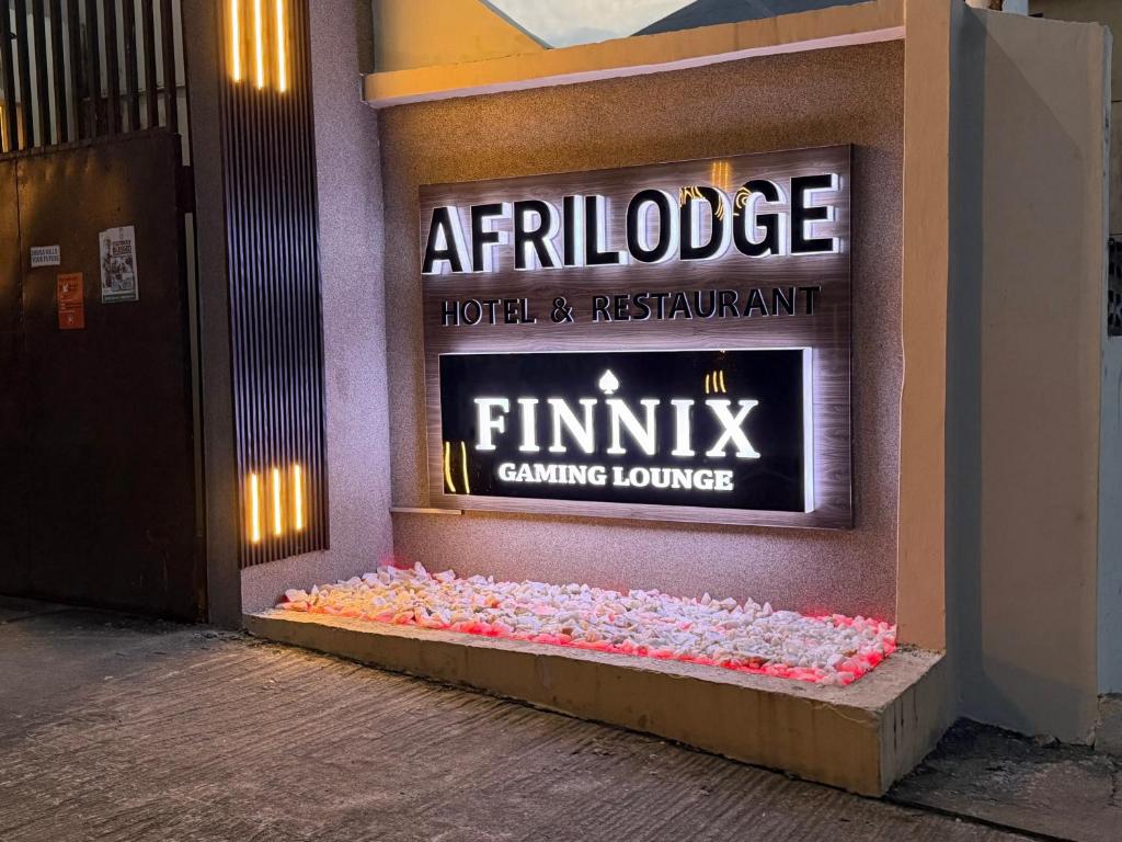 a entrance to a hotel and restaurant with a sign at Afrilodge Liberia in Monrovia