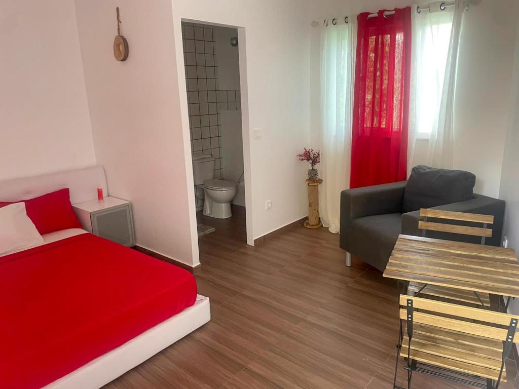 a living room with a red bed and a couch at Rubera - Refúgios & Sabores in Nora
