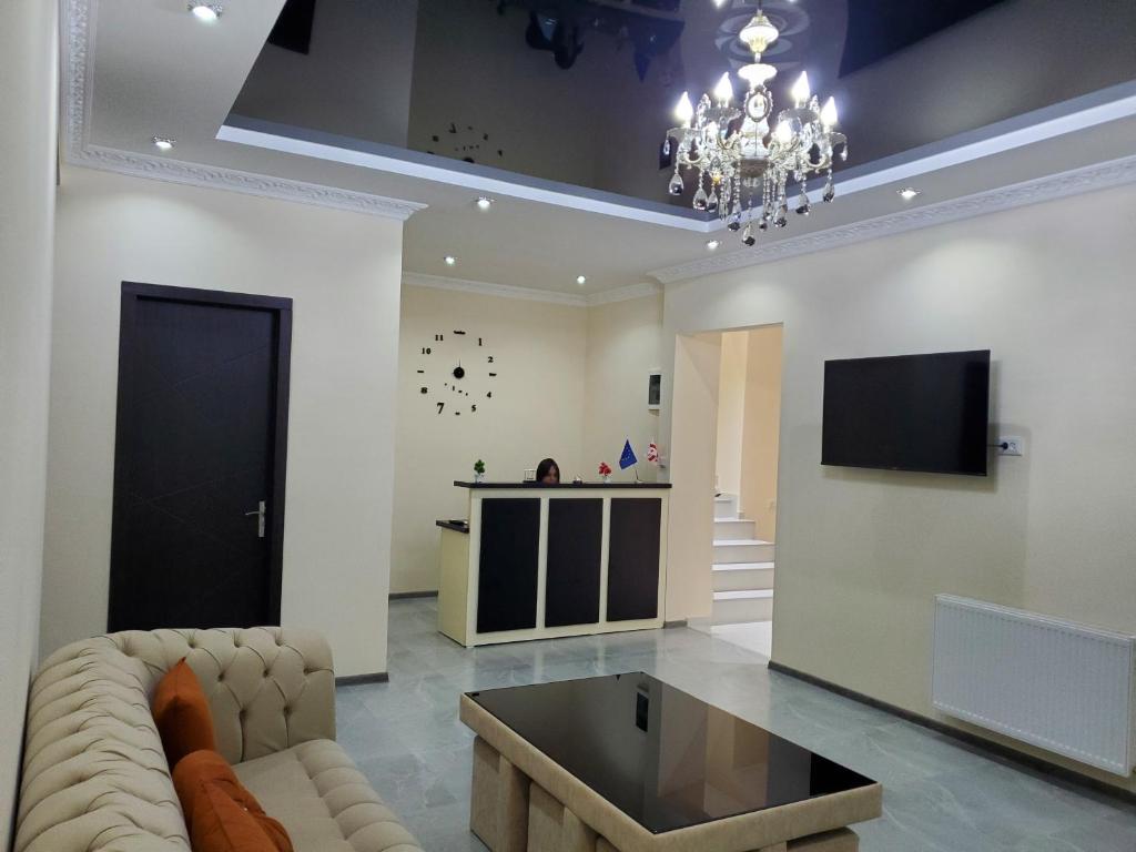 a living room with a couch and a tv at Hotel N in Tsqaltubo