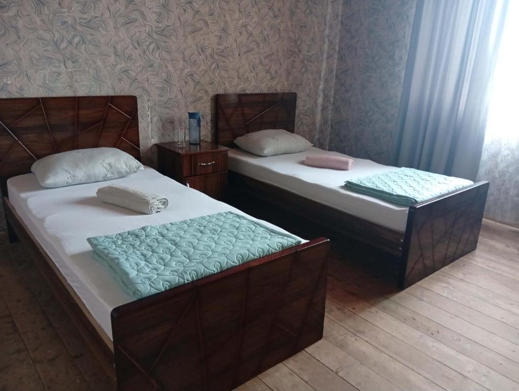 two beds sitting next to each other in a room at Guest house TASO in K'veda Gordi