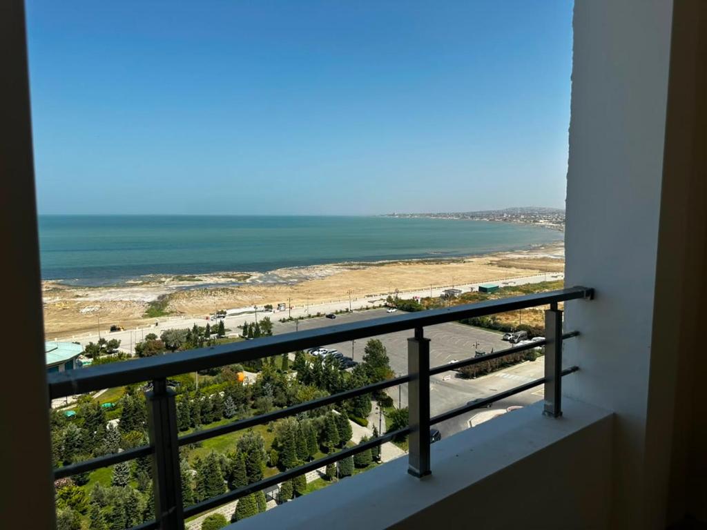 a balcony with a view of the beach at Caspian Boulevard Residence in Sumqayıt