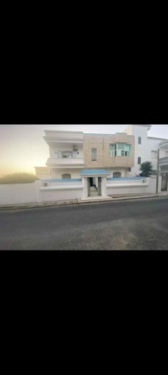 a large building on the side of a street at villa zgolli in Korba