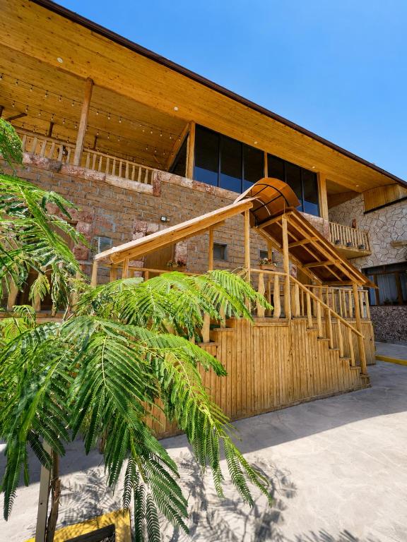 a house with a wooden staircase in front of it at NUR TOON in Areni