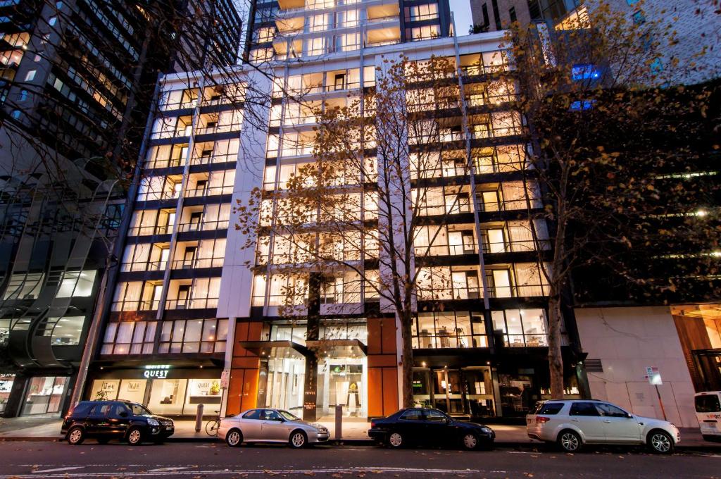 a tall building with cars parked in front of it at Quest Southbank in Melbourne