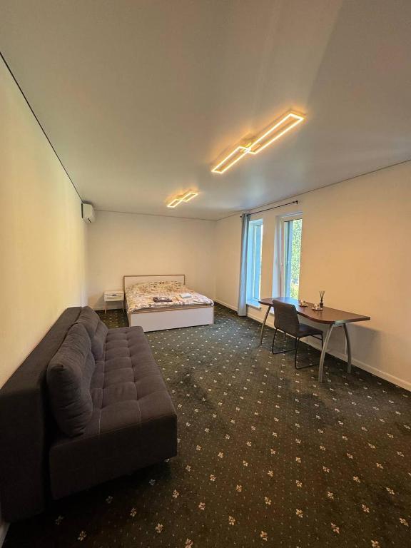 a room with a couch and a bed and a table at Хрю-хрю in Brovary
