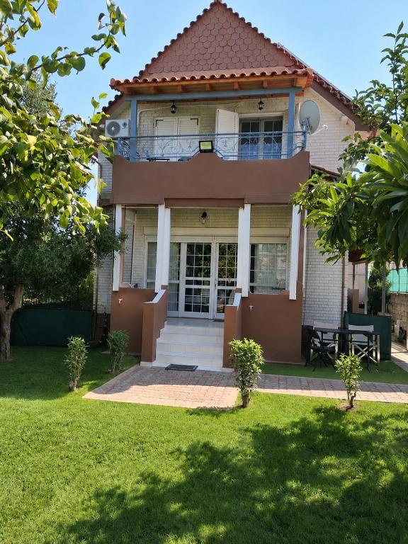 a house with a porch and a balcony at Galini Home 2 in Prokópion
