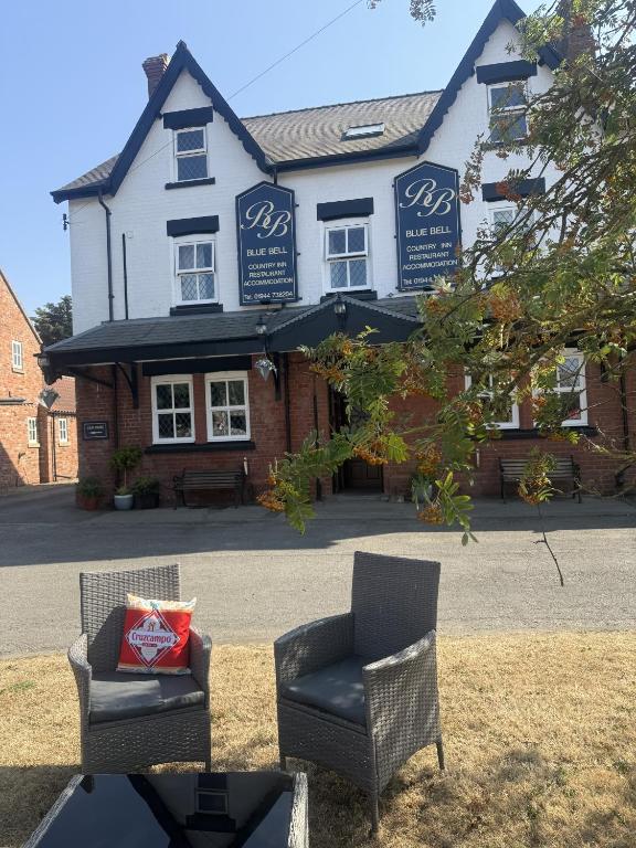 a couple of chairs sitting in front of a building at The Blue Bell Inn in Weaverthorpe
