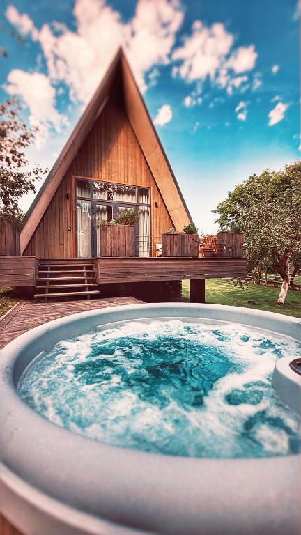 a large hot tub in front of a house at Mulberynas in Stakliškės