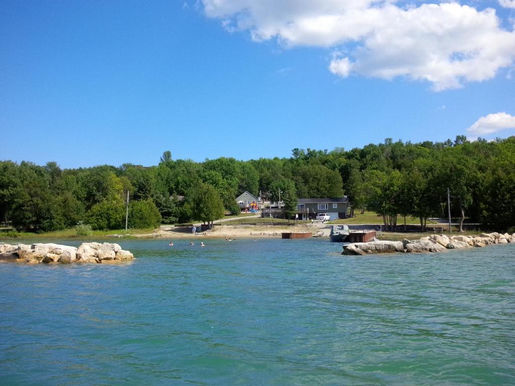 a view of a river with rocks in the water at Bayshore Cottages in Wiarton